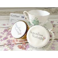 Dainty and delicious display of logo cupcakes for Peace Love Vintage