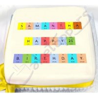 A birthday cake displaying a message written using elements