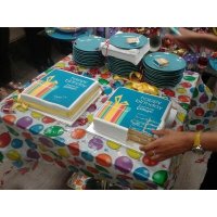Furniture Village celebrating their birthday with logo cakes